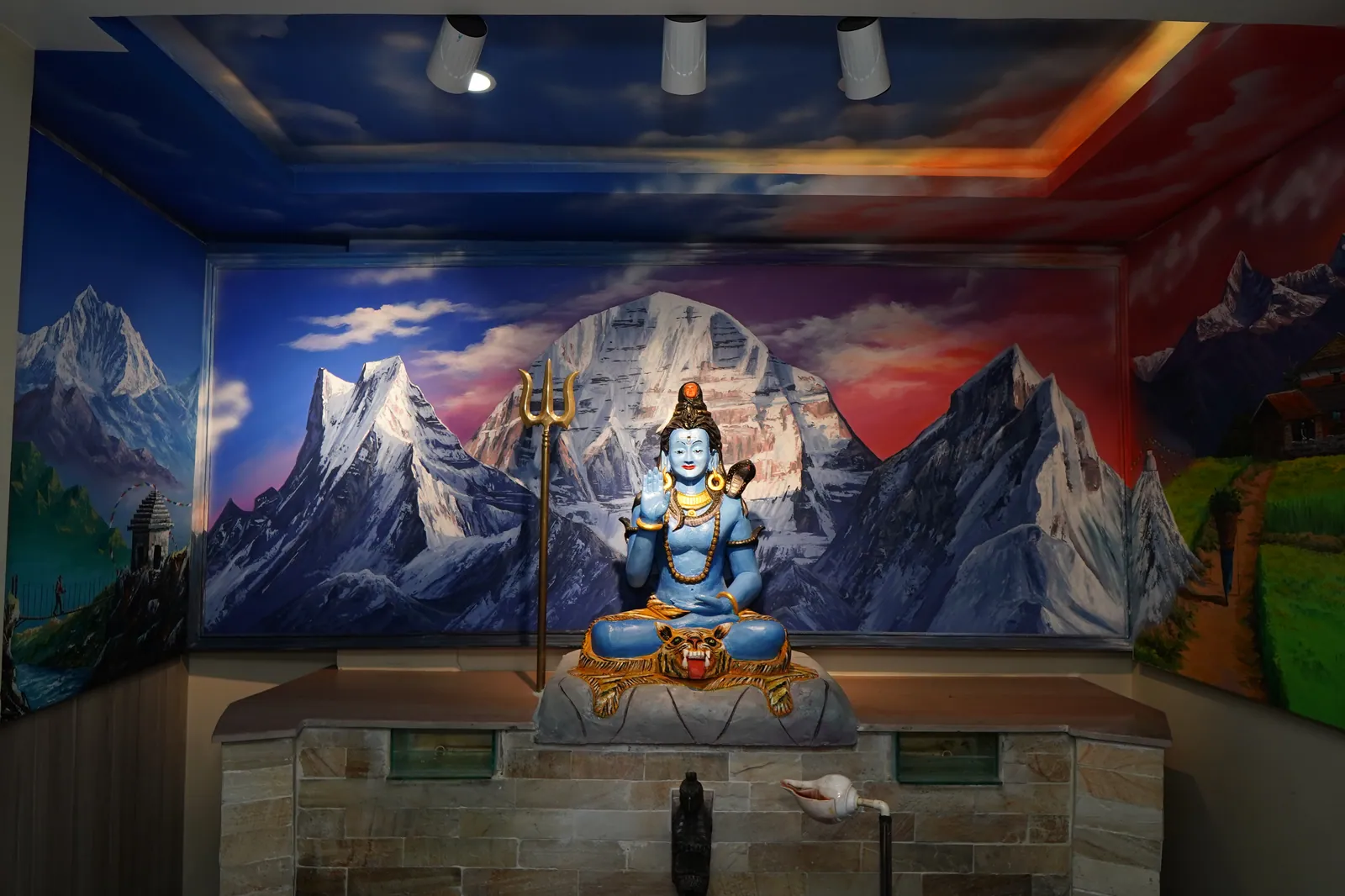 The Lord Shiva shrine at Jhigu Casa, set against a hand-painted Mount Kailash mural.