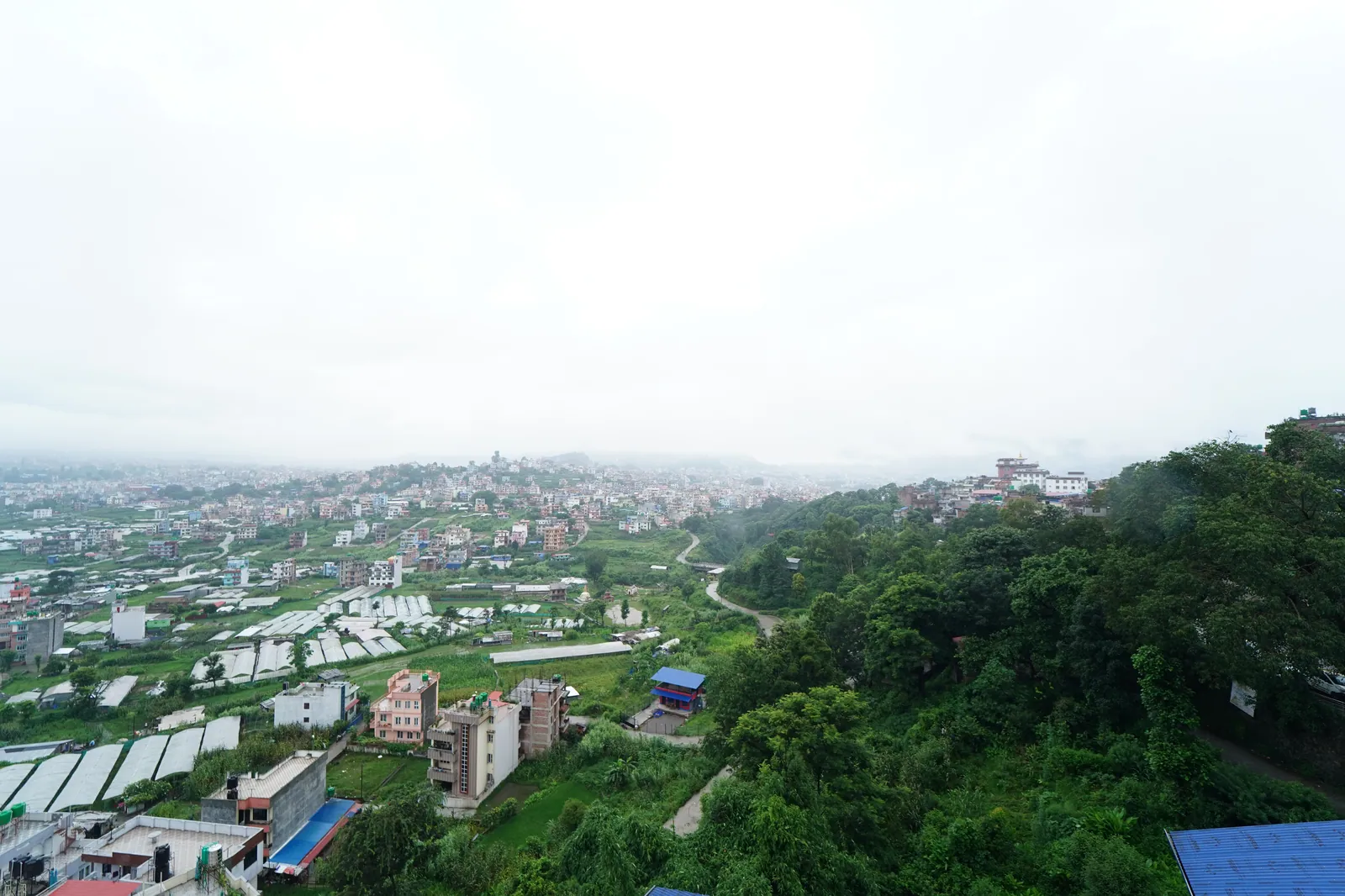 A beautiful southwest-facing view from the Jhigu Casa unit, capturing the valley, greenery, and distant hills.